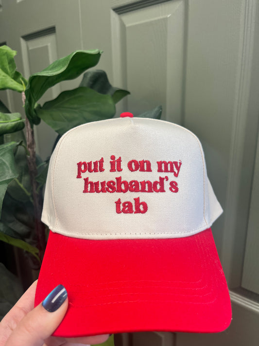 Put it on my husband's tab Trucker Hat